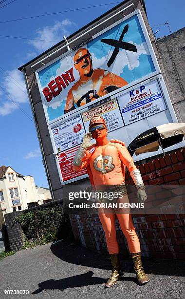 Captain Beany, leader of the New Millennium Bean Party, poses for pictures in front of his party's election billboard next to the The Red Lion pub,...