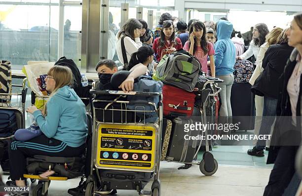 People wait at Madrid Barajas airport on April 20 after some planes remain grounded as a result of the volcanic eruption in Iceland. Airspace across...