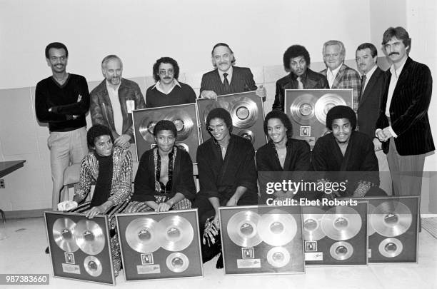 Michael Jackson with The Jacksons, receiving gold record awards for Michael's 'Off The Wall' album, backstage with CBS record executive Don Dempsey...