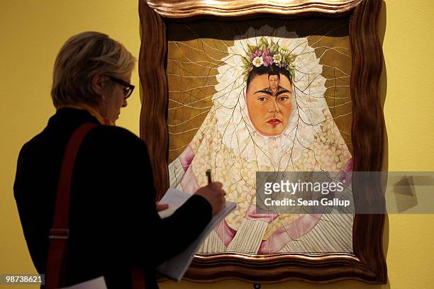 Visitor looks at "Self-Portrait as Tehuana or Diego on My Mind" by Mexican painter Frida Kahlo at the Frida Kahlo Retrospective at Martin-Gropius-Bau...