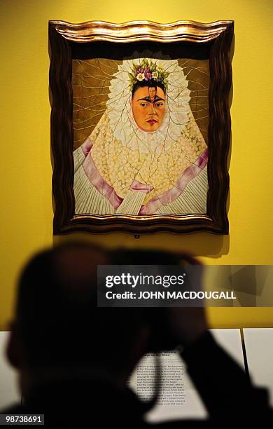 Photographer takes pictures of the painting "Self-Portrait as Tehuana or Diego on My Mind" by Mexican artist Frida Kahlo during a press preview on...