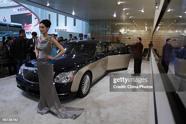 Chinese visitors checks out a German luxury limousine manufactured by Maybach at the Beijing Auto Show on April 29, 2010 in Beijing, China. The...