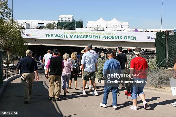 Spectators walk in for the first round of the Waste Management Phoenix Open at TPC Scottsdale on February 25, 2010 in Scottsdale, Arizona.