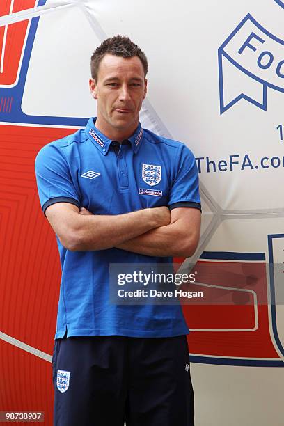 John Terry of England tackles a giant football at Wembley Stadium, the event was to mark the launch of The FA's England Football Day and encourage...