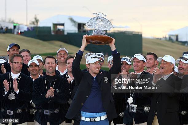 Hunter Mahan is celebrates his victory while holding the trophy after winning the Waste Management Phoenix Open at TPC Scottsdale on February 28,...