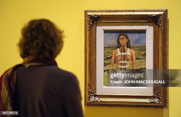 Visitor looks at the painting "The Broken Column" by Mexican artist Frida Kahlo during a press preview on April 29, 2010 at the Martin-Gropius-Bau...