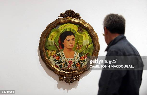 Visitor looks at the painting "Portrait of Marucha Lavin" by Mexican artist Frida Kahlo during a press preview on April 29, 2010 at the...