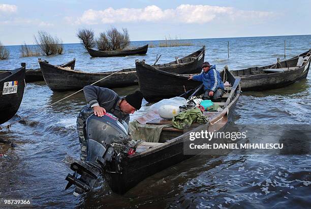 Isabelle WESSELINGH A Lipovan fisherman stops the engine of his boat on lake Razelm in Sarichioi village, 250kms east of Bucharest, on April 3, 2010....