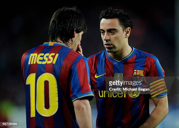 Xavi of Barcelona talks to team mate Lionel Messi during the UEFA Champions League Semi Final Second Leg match between Barcelona and Inter Milan at...