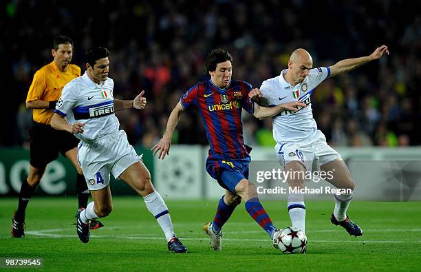 Lionel Messi of Barcelona is tackled by Javier Zanetti and Esteban Cambiasso of Inter Milan during the UEFA Champions League Semi Final Second Leg...