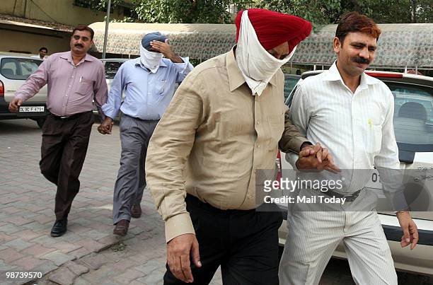 Surender Singh and Jiten Pal Singh, involved in the Rs 2 crore MCI graft case, outside the Patiala House Court in New Delhi on Wednesday, April 28,...