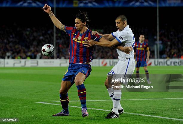 Zlatan Ibrahimovic of Barcelona holds off Walter Samuel of Inter Milan during the UEFA Champions League Semi Final Second Leg match between Barcelona...