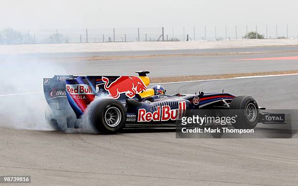 David Coulthard of Great Britain wheelspins out on the track in a Red Bull Formula One car during the launch of the new Grand Prix circuit at...