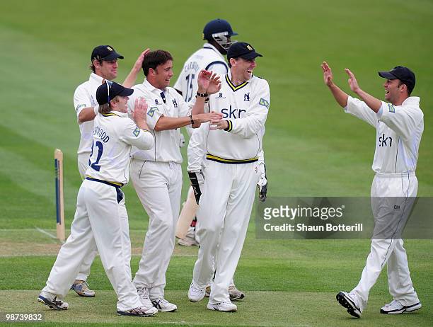 Neil Carter of Warwickshire is congratulated by team-mates after taking the wicket of Michael Carberry of Hampshire during the LV County Championship...