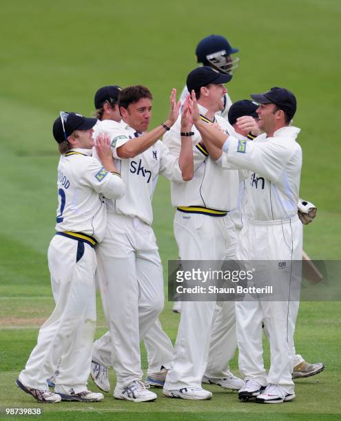 Neil Carter of Warwickshire is congratulated by team-mates after taking the wicket of Michael Carberry of Hampshire during the LV County Championship...