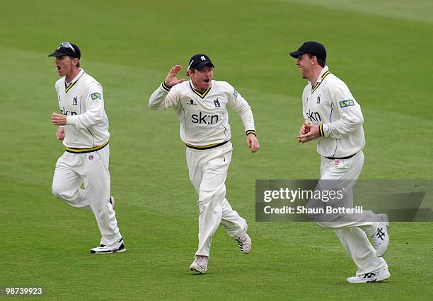 Ian Bell of Warwickshire celebrates with team-mates Rikki Clarke and Darren Maddy after the wicket of Neil McKenzie of Hampshire during the LV County...