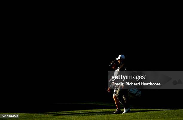 Lee Westwood of England walks down the 12th fairway with caddy Billy Foster during the first round of the Quail Hollow Championship at Quail Hollow...