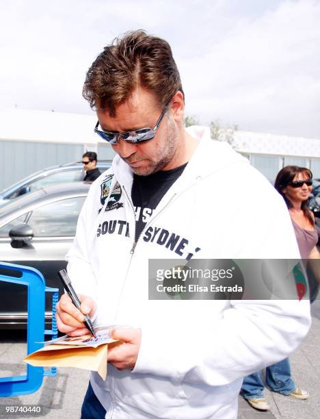 Actor Russell Crowe signs autographs during a visit to Valdebebas on April 29, 2010 in Madrid, Spain.