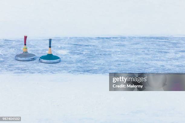 curling stones on outdoors curling rink. ice stock sport. - curling stock-fotos und bilder