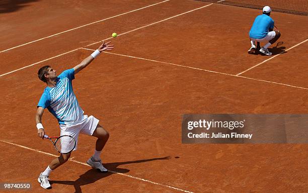 Max Mirnyi of Belarus and Mahesh Bhupathi of India in action in their doubles match against John Isner and Sam Querrey of USA during day five of the...
