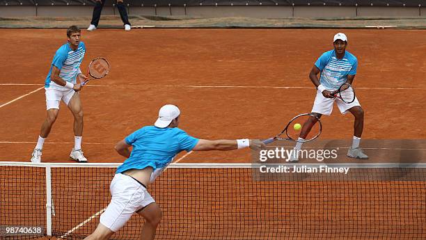 Max Mirnyi of Belarus and Mahesh Bhupathi of India in action in their doubles match against John Isner and Sam Querrey of USA during day five of the...