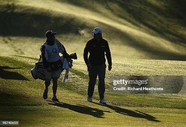 Lee Westwood of England walks down the 11th fairway with caddy Billy Foster during the first round of the Quail Hollow Championship at Quail Hollow...