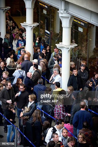 Travellers queue for Eurostar tickets at Kings Cross St Pancras railway station in central London on April 17, 2010. Nearly 17,000 flights in...