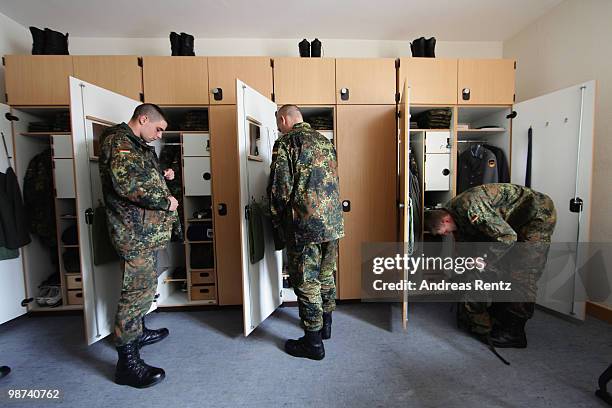 Young recruits of the German Bundeswehr get dressed in their living room during their nine months military service at the Julius Leber barracks on...