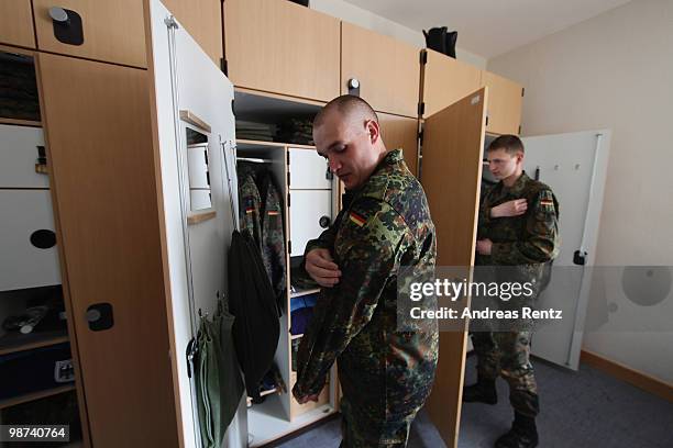 Young recruits of the German Bundeswehr get dressed in their living room during their nine months military service at the Julius Leber barracks on...