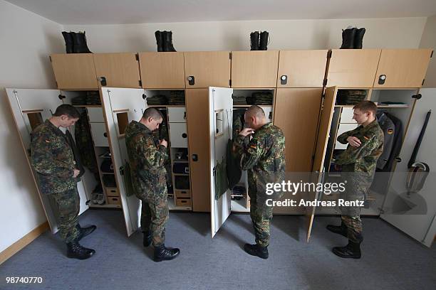 Young recruits of the German Bundeswehr get dressed in their living room during their nine months military service at the Julius Leber barracks on...