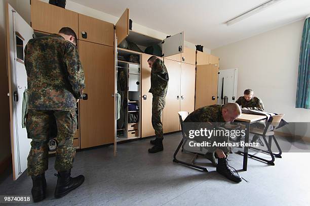 Young recruits of the German Bundeswehr get dressed in their living room during their nine months military service at the Julius Leber barracks on...