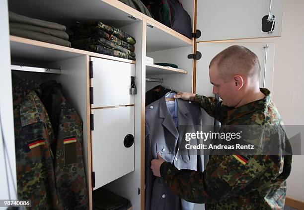 The young recruit Koenig of the German Bundeswehr takes out a jacket from his locker in his living room during his nine months military service at...