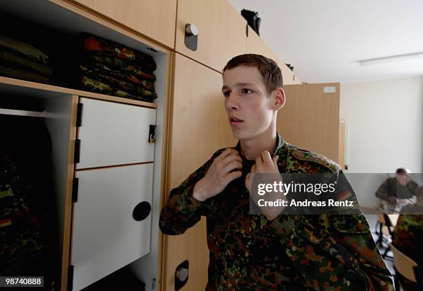 The young recruit Schirmer of the German Bundeswehr gets dressed in his living room during his nine months military service at the Julius Leber...