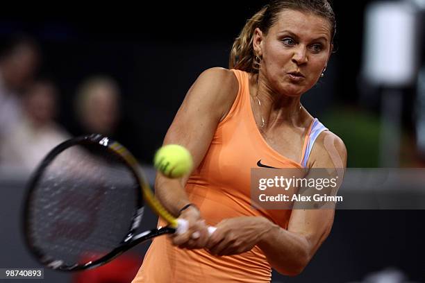 Lucie Safarova of Czech Republic plays a backhand during her second round match against Caroline Wozniacki of Denmark at day four of the WTA Porsche...