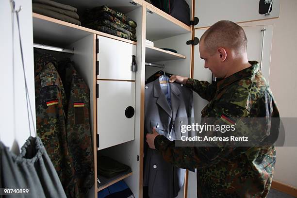 The young recruit Koenig of the German Bundeswehr takes out a jacket from his locker in his living room during his nine months military service at...