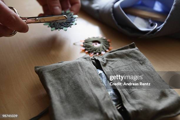 Detail of a sewing kit is pictured as a young recruit of the German Bundeswehr is sewing on a button on his jacket in his living room during his nine...