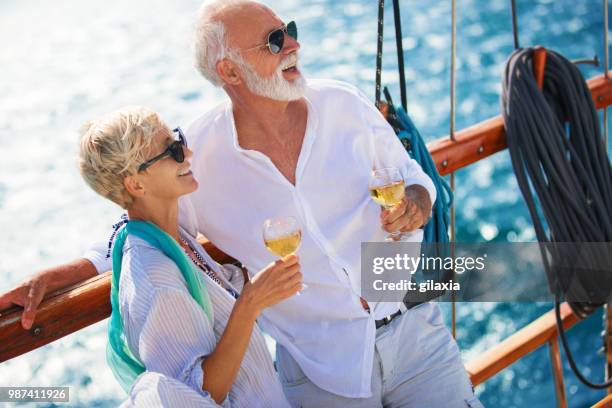 senior couple on a sailing cruise. - gilaxia stock pictures, royalty-free photos & images