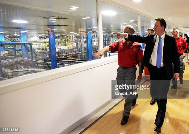 British opposition Conservative party Leader, David Cameron gestures as he is shown around a Coca-Cola factory during an election campaign visit to...