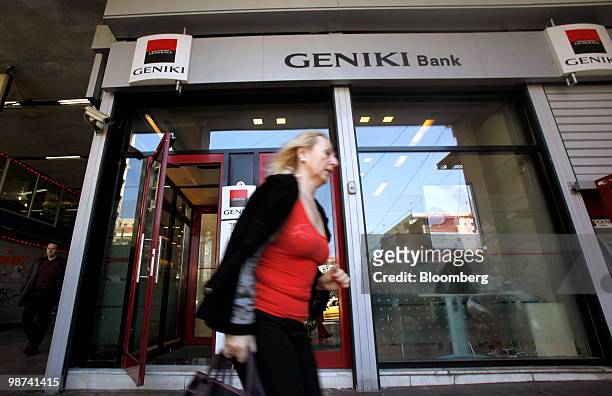 Pedestrian walks past a branch of Geniki bank in Athens, Greece, on Thursday, April 29, 2010. Credit Agricole SA and Societe Generale SA may be among...