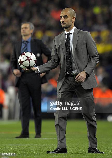 Barcelona's coach Pep Guardiola holds the ball next to Inter Milan's Portuguese coach Jose Mourinho during the UEFA Champions League semi-final...