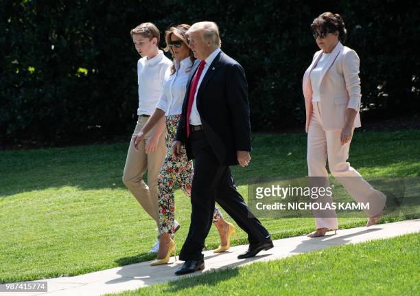 President Donald Trump , First Lady Melania Trump , their son Barron and Melania Trump's mother Amalija Knavs walk to board Marine One at the White...