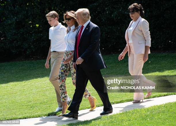 President Donald Trump , First Lady Melania Trump , their son Barron and Melania Trump's mother Amalija Knavs walk to board Marine One at the White...