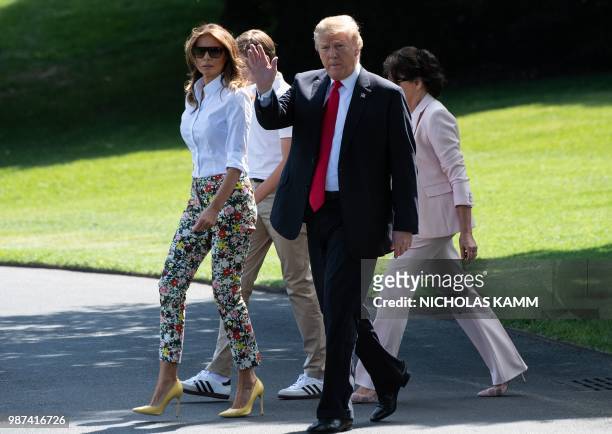 President Donald Trump , First Lady Melania Trump , their son Barron and Melania Trump's mother Amalija Knavs walk to board Marine One at the White...