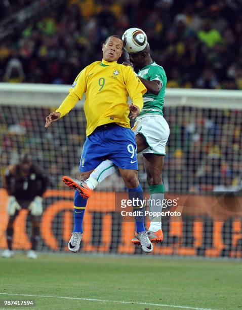 Luis Fabiano of Brazil and Didier Zokora of the Ivory Coast battle for the ball during a FIFA World Cup Group G match at the Soccer City Stadium on...