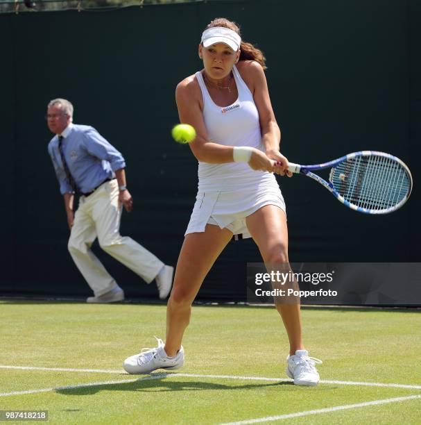 Agnieszka Radwanska of Poland returns the ball against Melinda Czink of Hungary in the Womens Singles first round on day two of the 2010 Wimbledon...