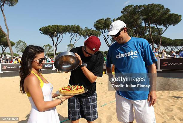 Bob and Mike Bryan of USA receive a cake on their birthday after playing some beach tennis during day five of the ATP Masters Series - Rome at the...