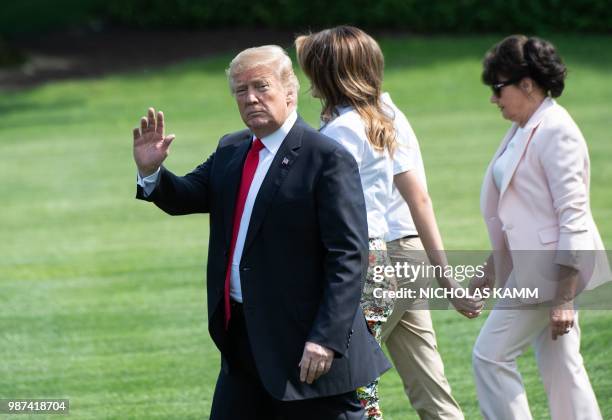 President Donald Trump , First Lady Melania Trump , their son Barron and Melania Trump's mother Amalija Knavs walk to board Marine One at the White...