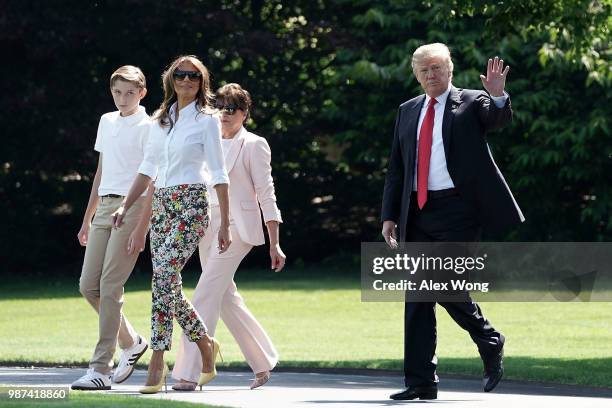 President Donald Trump , first lady Melania Trump , their son Barron Trump , and mother-in-law Amalija Knavs walk on the South Lawn of the White...