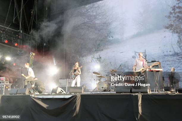 Joff Oddie, Ellie Rowsell, Joel Amey and Theo Ellis of Wolf Alice support Liam Gallagher on stage at Finsbury Park on June 29, 2018 in London,...