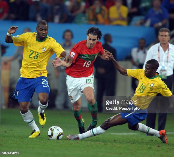 Tiago of Portugal is crowded out by Grafite and Ramires of Brazil during a FIFA World Cup Group G match at the Moses Mabhida Stadium on June 25, 2010...